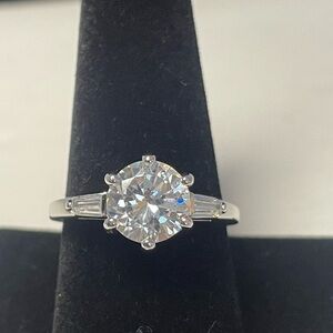 Large round cubic zirconia solitaire ring with baguette CZ on each side. Size 10